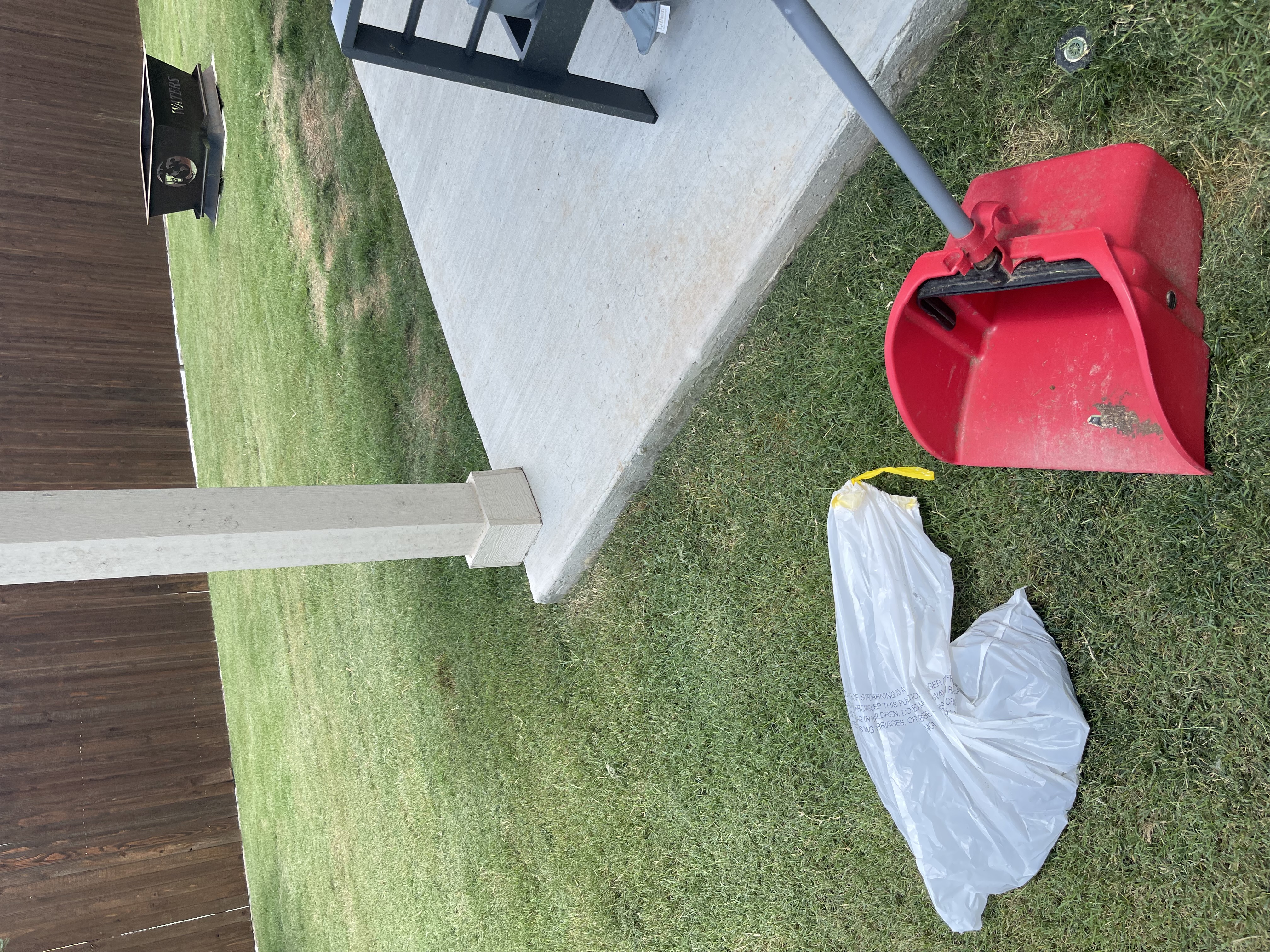 A1 Scoop Warriors pooper scooper service completed on a manicured backyard with deck and patio furniture